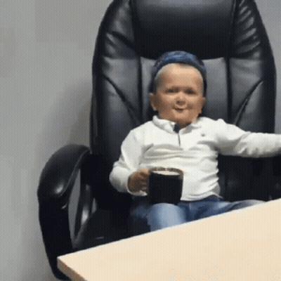 Boy Sitting In Chair Holding Coffee GIF