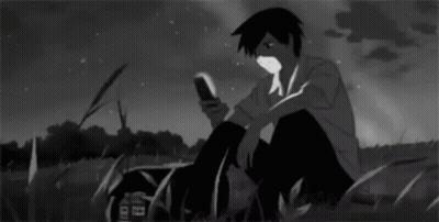 Boy Sitting In Grass Looking At Phone GIF