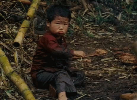 Boy Sitting In Mud With Crossed Arms GIF