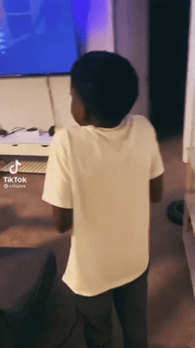 Boy Standing In Front Of TV With Tik Tok GIF