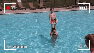 Boy Standing On Man's Shoulders In Pool GIF