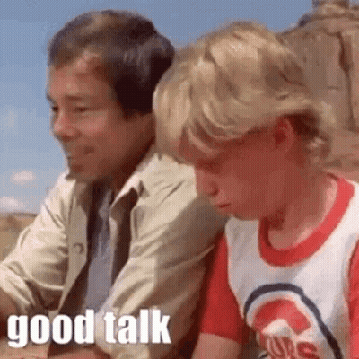 Boy Talking To Seated Man GIF