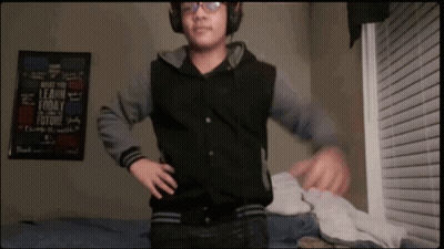 Boy Wearing Headphones In Front Of Learn Today Sign GIF
