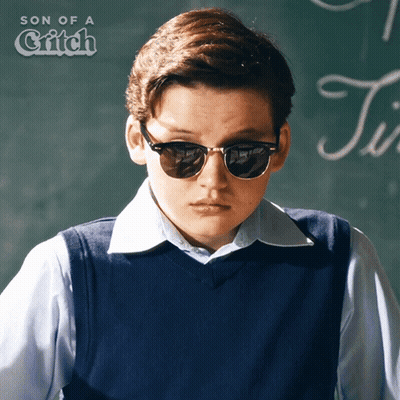 Boy Wearing Sunglasses In Front Of Blackboard GIF
