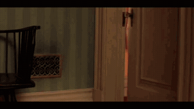Boy With Glasses And Red Jacket By Green Wall GIF