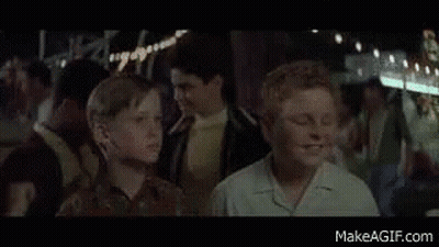 Boy With Glasses In Front Of T2 Sign GIF