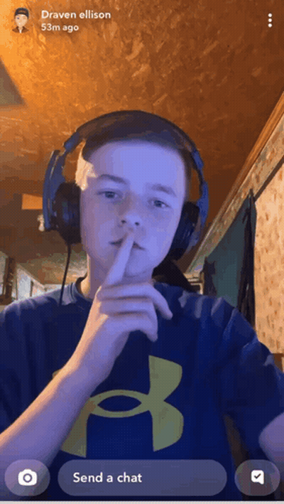 Boy With Headphones Shushing In Blue Under Armour Shirt GIF
