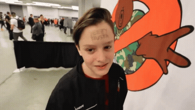 Boy With Leey Busta On Forehead In Front Of Cartoon GIF