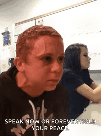Boy With Red Hair Sitting At Desk GIF