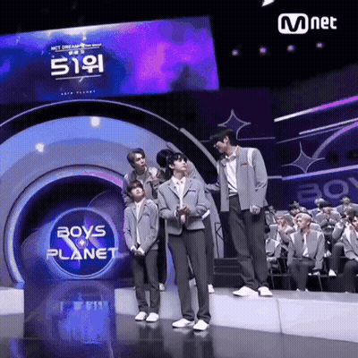 Boys Standing On Stage In Front Of Boys Planet Sign GIF