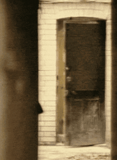 Brick Building With Open Door GIF