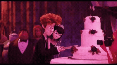 Bride And Groom Cutting Wedding Cake GIF