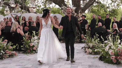 Bride And Groom Holding Hands Down Aisle GIF