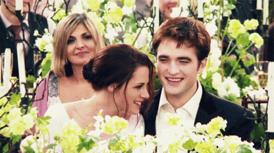 Bride And Groom Holding Hands With Man In Suit Behind GIF