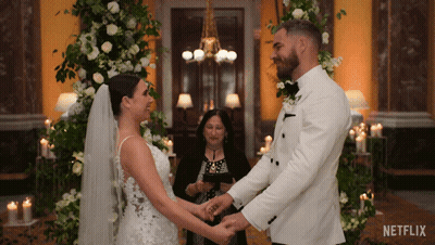 Bride And Groom Holding Hands With Netflix Logo GIF