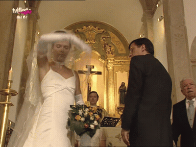 Bride And Groom In Front Of Crucifix With TVF Logo GIF