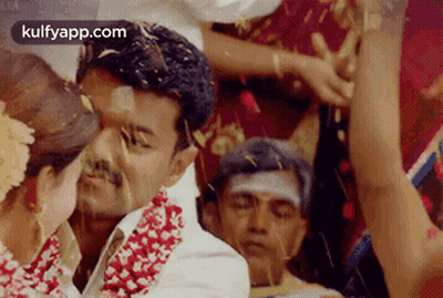 Bride And Groom Kissing At Wedding With Confetti GIF