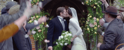 Bride And Groom Kissing In Front Of Crowd GIF
