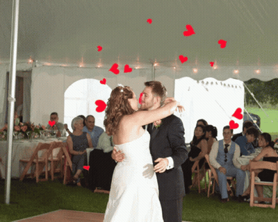 Bride And Groom Kissing Under White Tent GIF