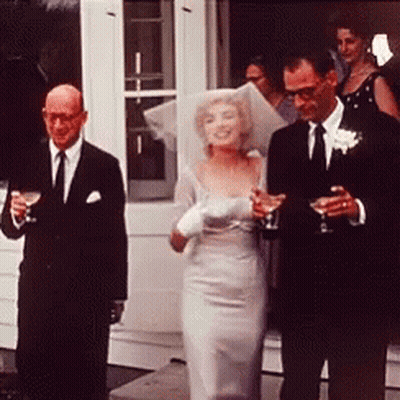Bride And Groom Walking Down Aisle Holding Wine Glasses GIF