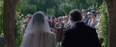 Bride And Groom Walking Down Aisle With Father GIF