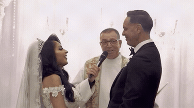 Bride And Groom With Priest Holding Microphone GIF