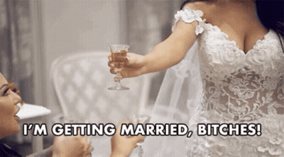 Bride In Wedding Dress Holding Champagne While Woman Toasts GIF