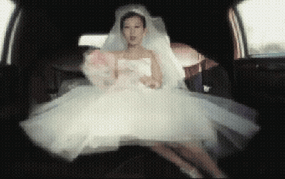 Bride In White Dress Sitting In Back Of Car GIF