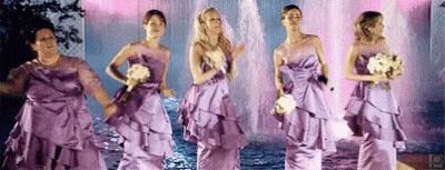 Bridesmaids In Purple Dresses Dancing By Fountain GIF