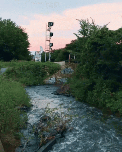 Bridge Over River With Graffiti And Sign A GIF