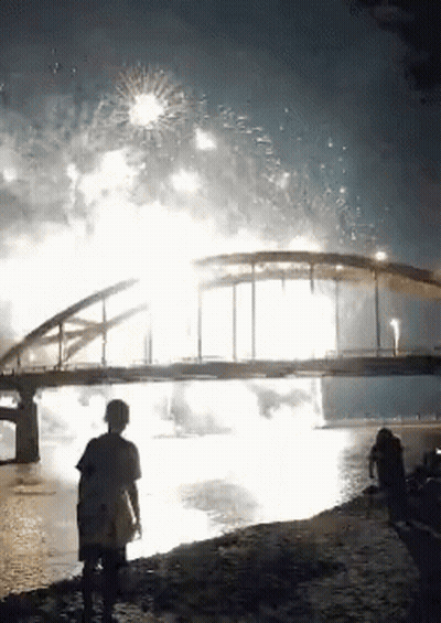 Bridge Over Water With Fireworks GIF