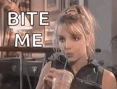 Britney Spears Is Drinking A Drink Through A Straw And Says `` Bite Me '' . GIF