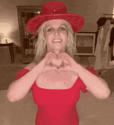 Britney Spears Making Heart Shape In Red Dress And Red Hat GIF