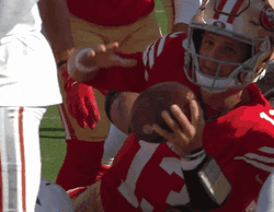 Brock Purdy Holding The Football GIF