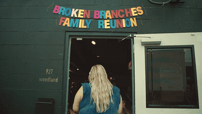 Broken Branches Family Reunion Is Advertised On A Black Building GIF