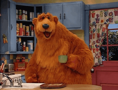 Brown Bear Holding Cup In Kitchen GIF