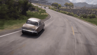 Brown Car Driving Past Avenida Sign GIF