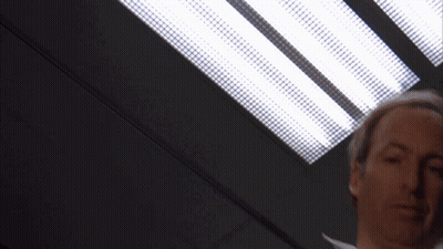 Brown Jacket White Shirt Man Under Ceiling Light GIF