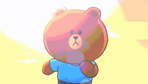 Brown Teddy Bear In Blue Shirt In Front Of Yellow Background GIF