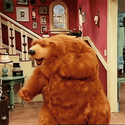 Brown Teddy Bear Standing In Living Room In Front Of Stairs GIF