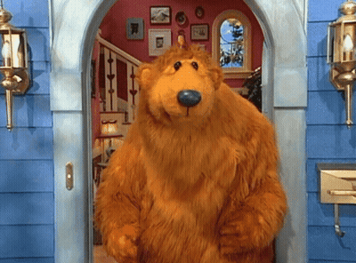 Brown Teddy Bear With Blue Nose Standing In Doorway GIF
