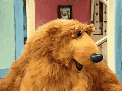 Brown Teddy Bear With Blue Nose Standing In Front Of Door GIF