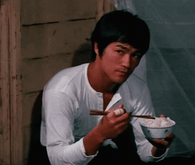 Bruce Lee Eating Rice With Chopsticks GIF