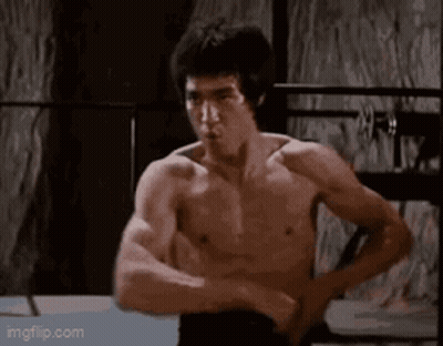 Bruce Lee Flexing Muscles In Boxing Ring GIF