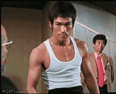 Bruce Lee In White Tank Top And Black Shorts GIF