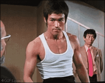 Bruce Lee In White Tank Top And Red Tie In Front Of Two Men GIF
