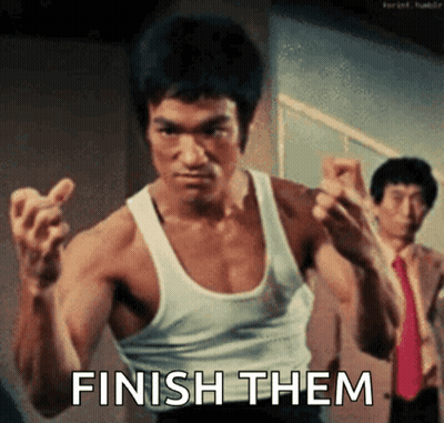 Bruce Lee In White Tank Top Making Fist Saying Finish Them GIF