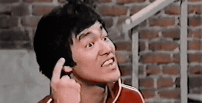 Bruce Lee Making Funny Face And Giving Middle Finger GIF