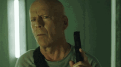 Bruce Willis Holding A Gun