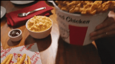 Bucket Of Fried Chicken On Wooden Table GIF